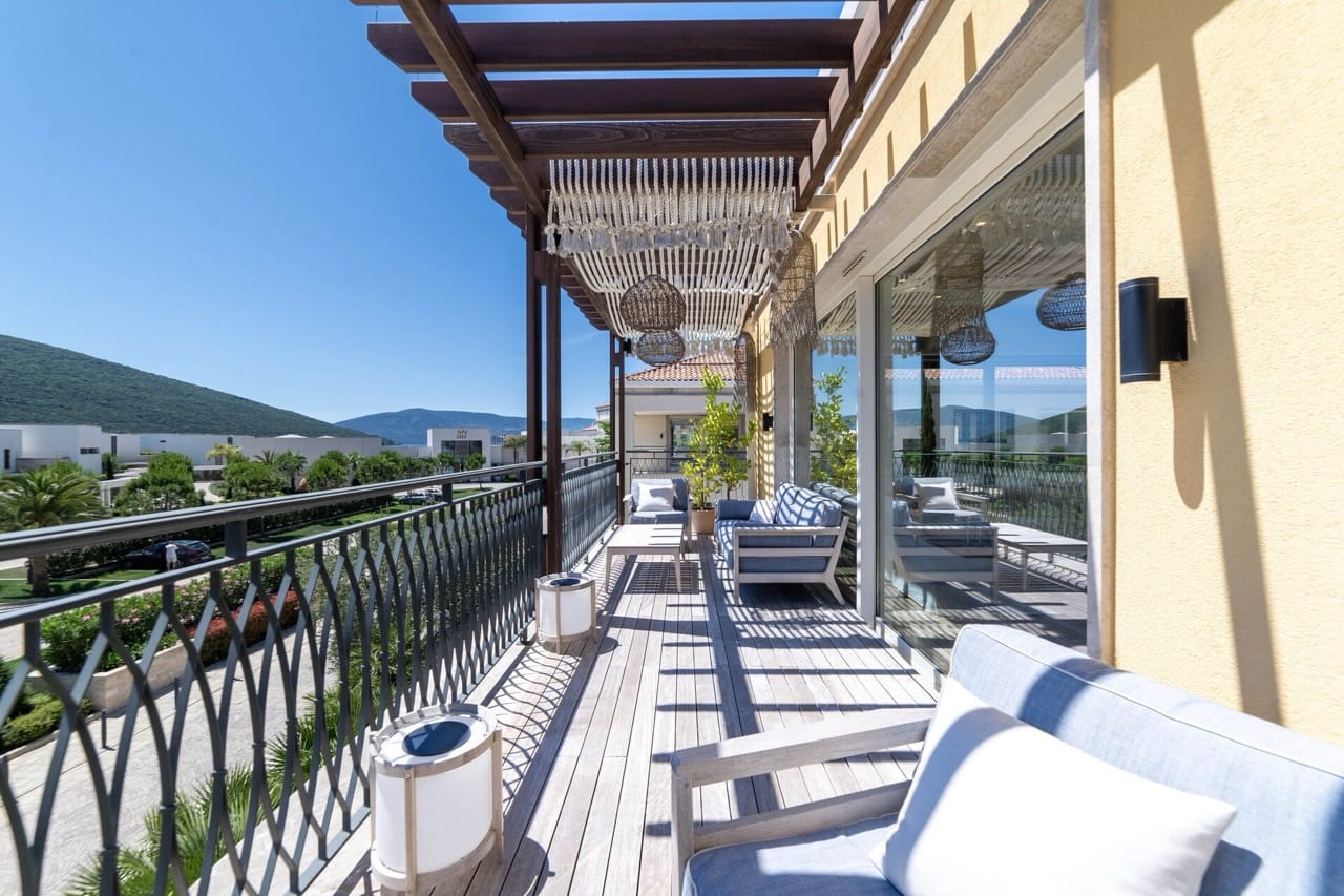 Spacious terrace with wooden decking and furniture in the Portonovi residential complex, Kumbor, Montenegro.