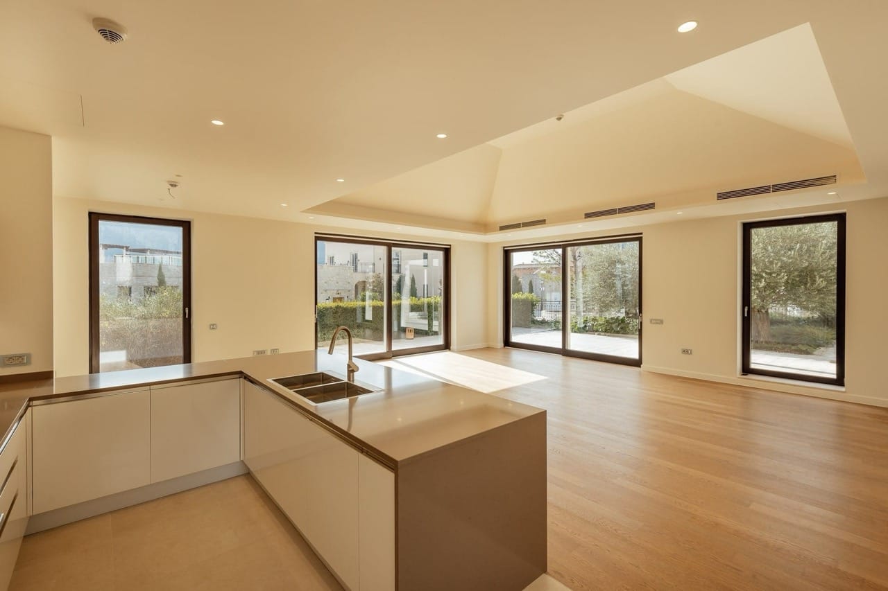 Modern kitchen-living room in a villa in Portonovi, Kumbor, Montenegro: panoramic windows, bright interior, and an island.