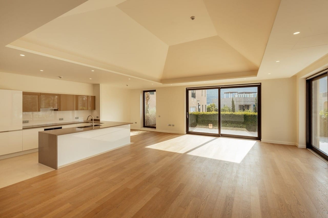 Modern kitchen-living room with panoramic windows in a villa in Portonovi, Kumbor, Montenegro. Bright interior with an island.