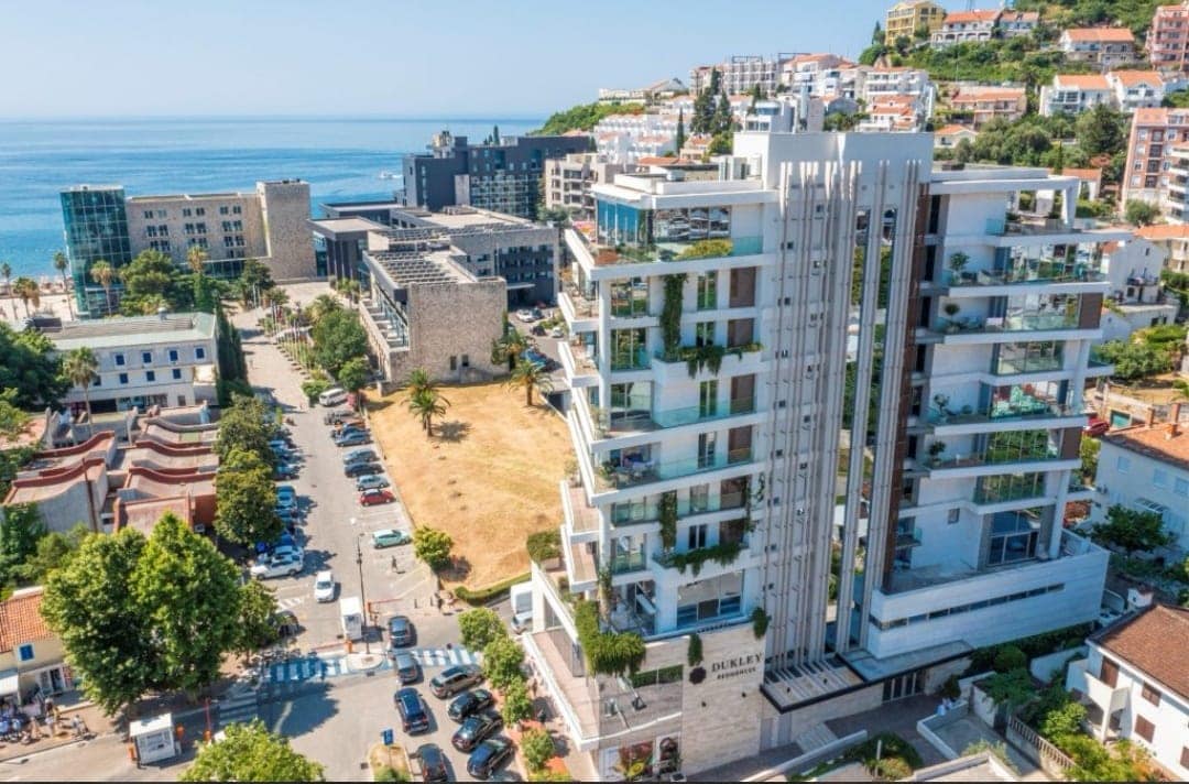 Aerial view of the luxury Dukley Residences residential complex in the center of Budva, Montenegro, near the seafront.