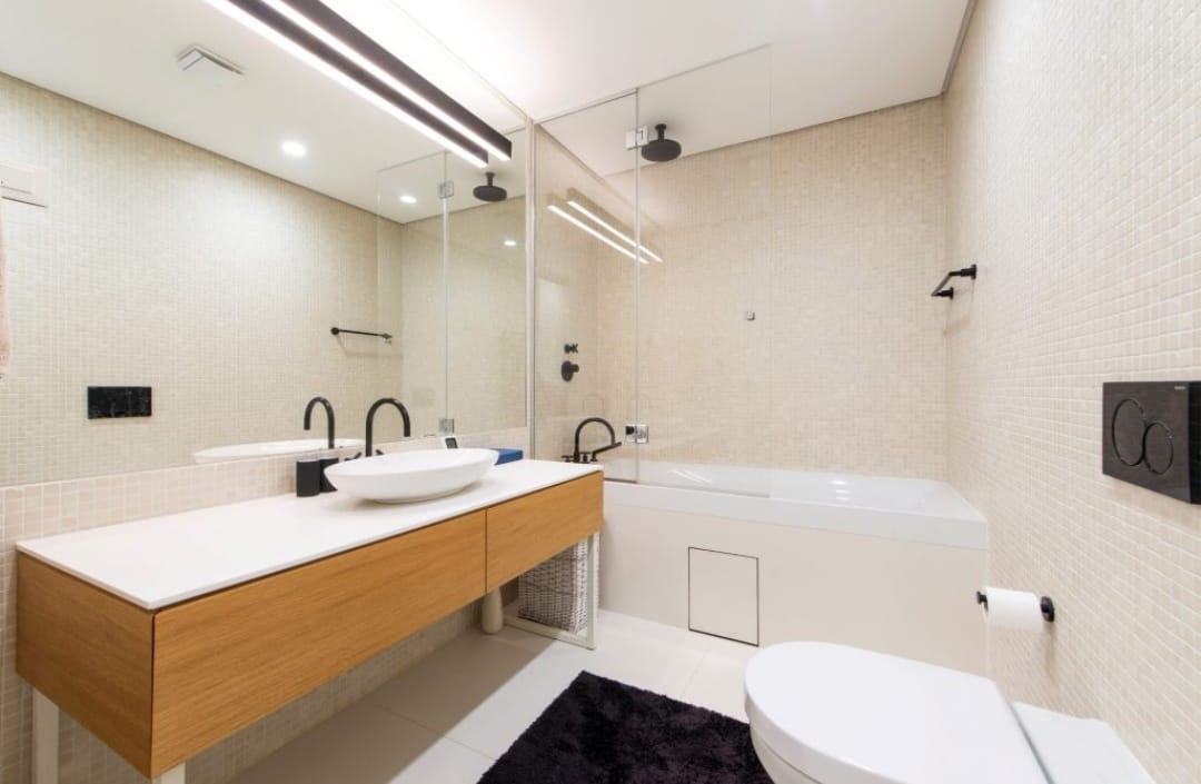 Modern bathroom with a shower cabin and wooden vanity in an apartment, Budva, Montenegro.