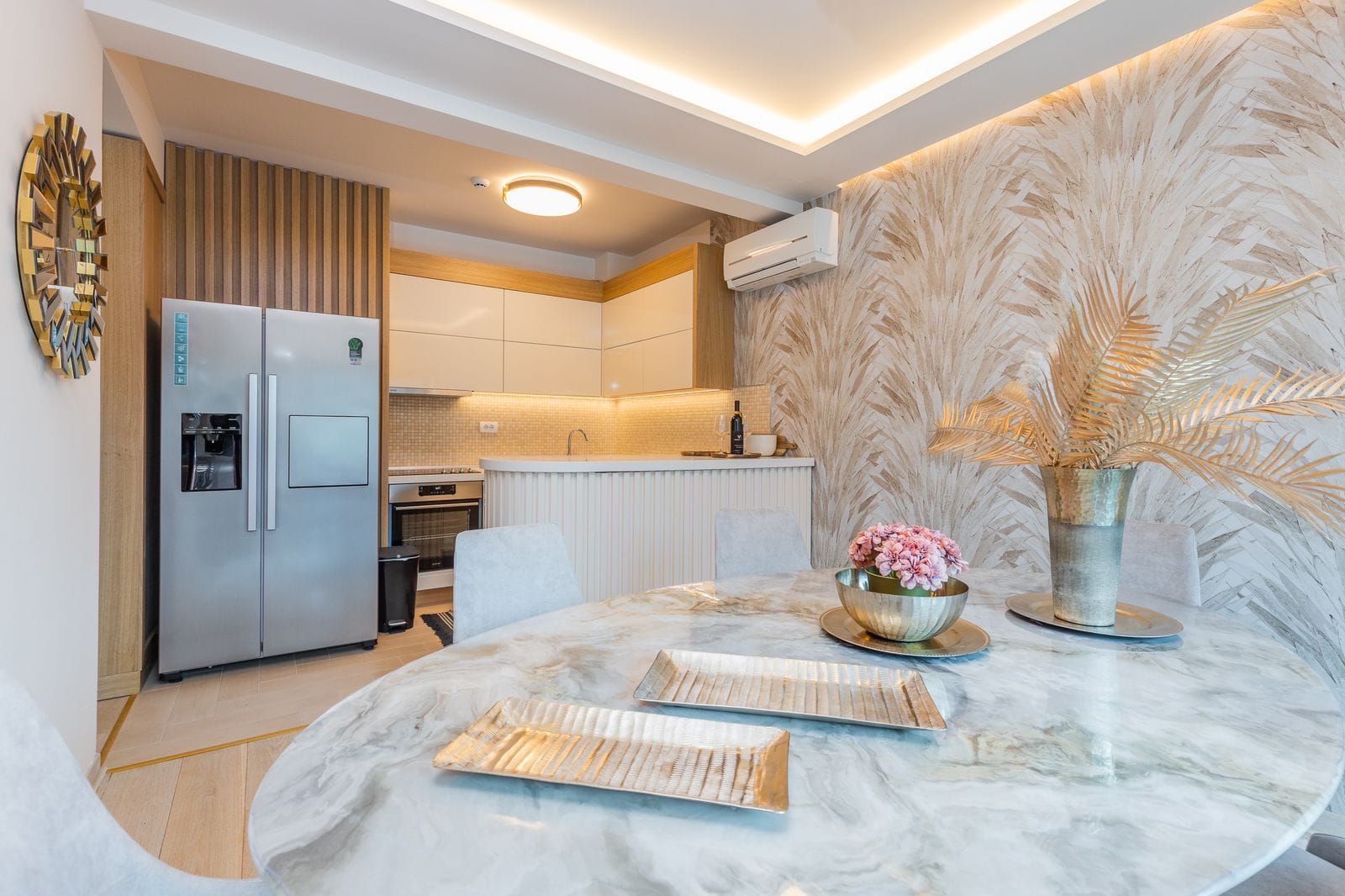 Modern kitchen-dining area in a penthouse, Pržno, Montenegro: marble table, designer decor, and built-in appliances.