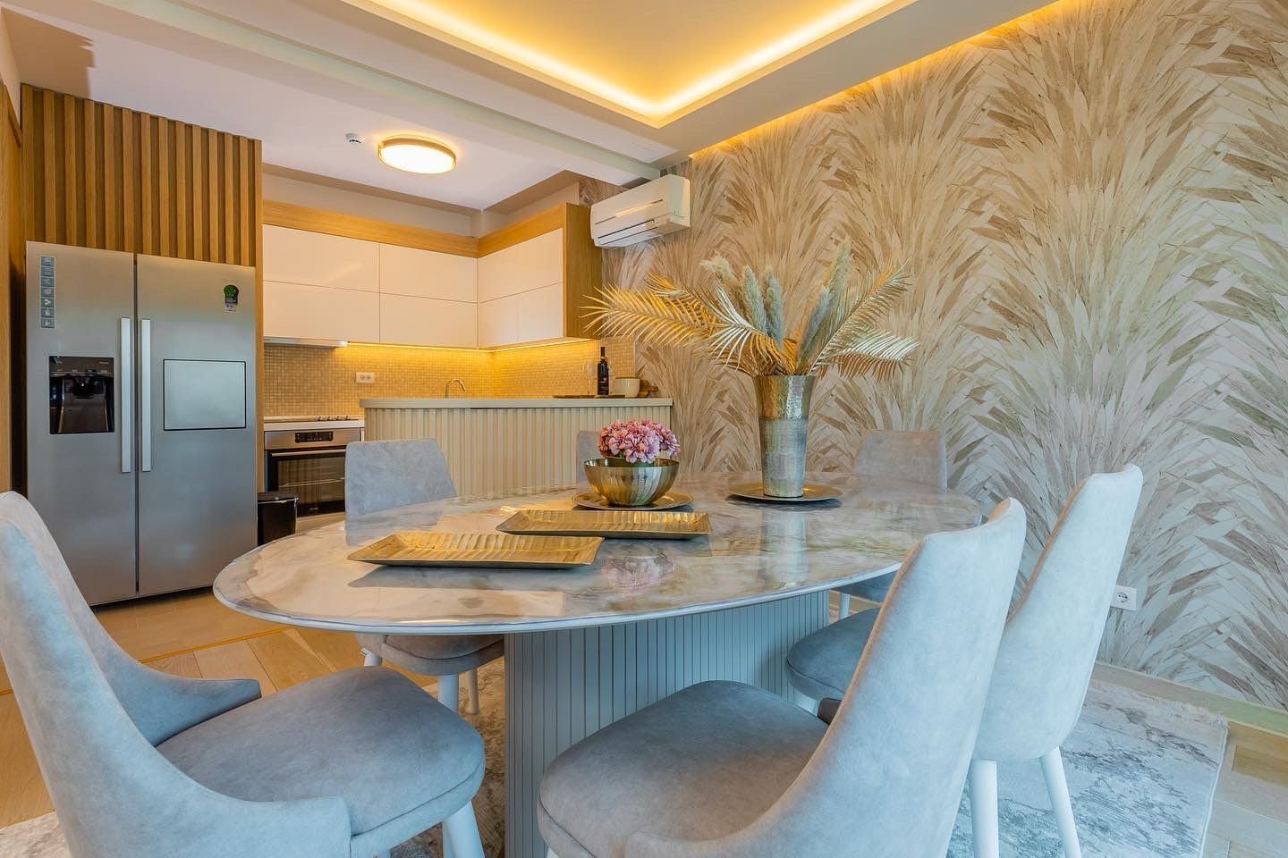 Modern kitchen-dining area in a penthouse in Pržno, Montenegro: marble dining table, stylish furniture and decor.