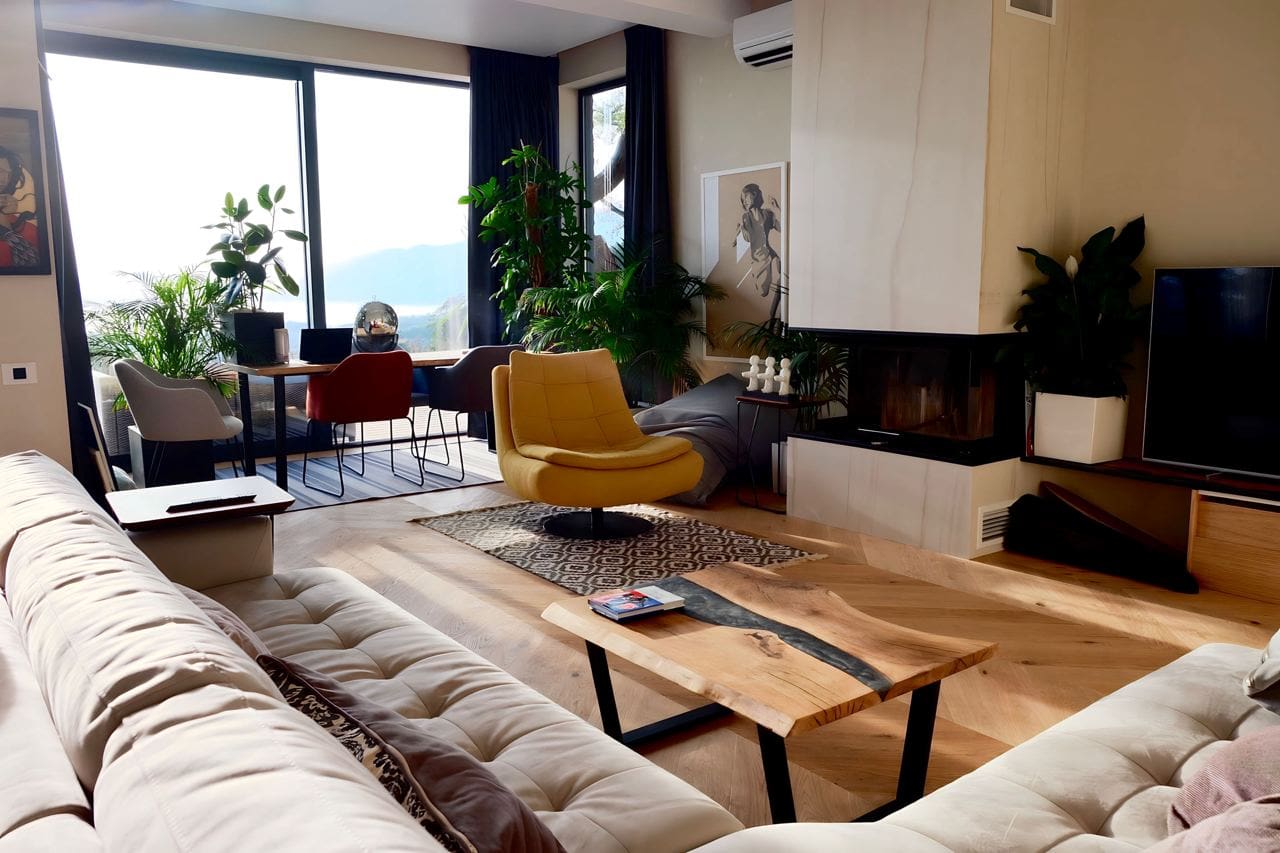 Modernes Wohnzimmer mit Kamin und Panoramablick im ЖК Kavač, Montenegro: stilvolle Möbel und Designer-Interieur.