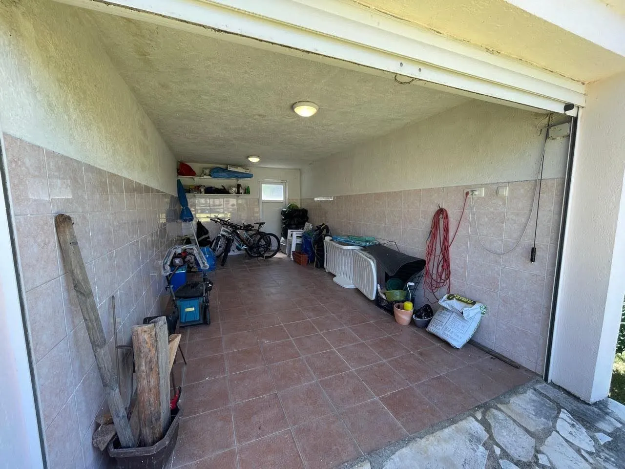 Spacious garage with tiled walls and floor in a private house, Bar, Montenegro.