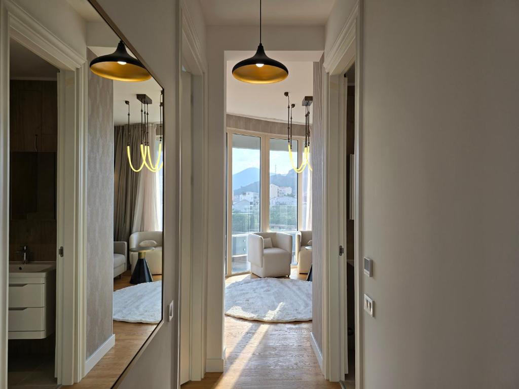 Moderner Flur und Wohnzimmer in einer Wohnung in Bečići, Montenegro: helles Interieur, Panoramafenster und Bergblick.