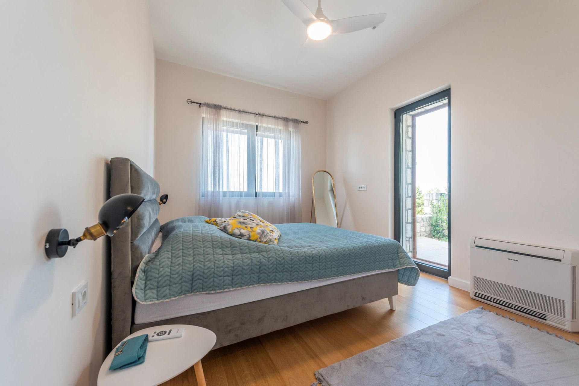 Chambre confortable avec lit double et accès à la terrasse dans une maison, Reževići, Monténégro. Intérieur moderne.