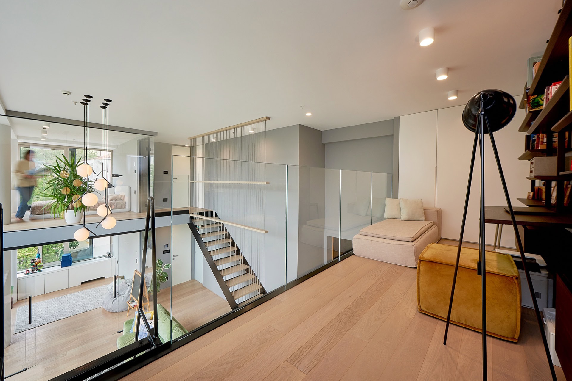 Moderne Maisonettewohnung in Budva, Montenegro: Wohnzimmer mit Glasgeländern und Treppe im Loft-Stil.