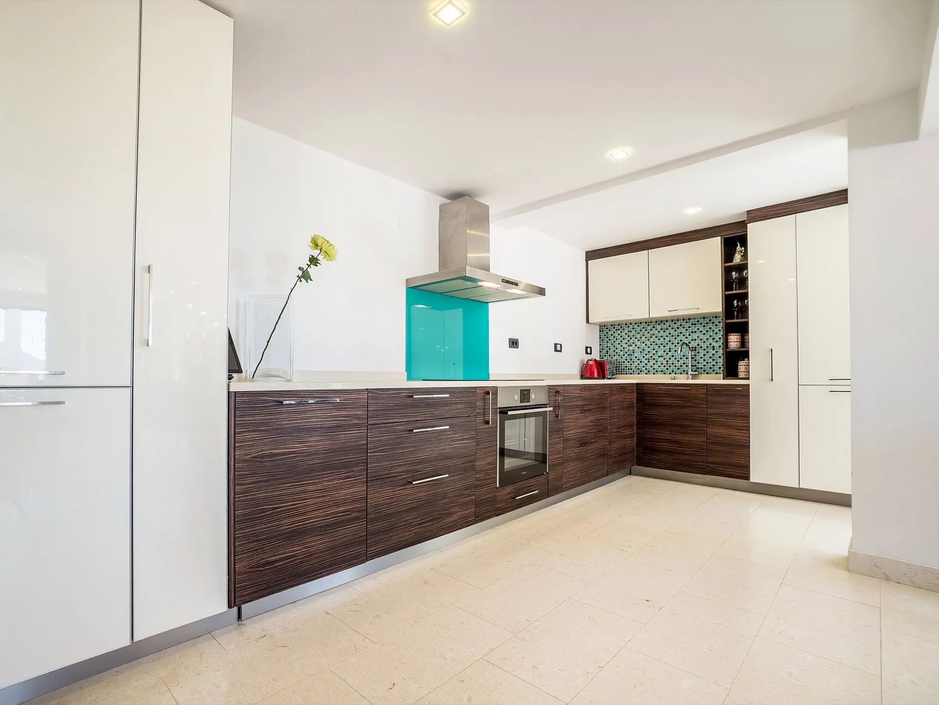 Modern kitchen with dark cabinets and a turquoise backsplash in a villa in Zanjice, Herceg Novi, Montenegro.