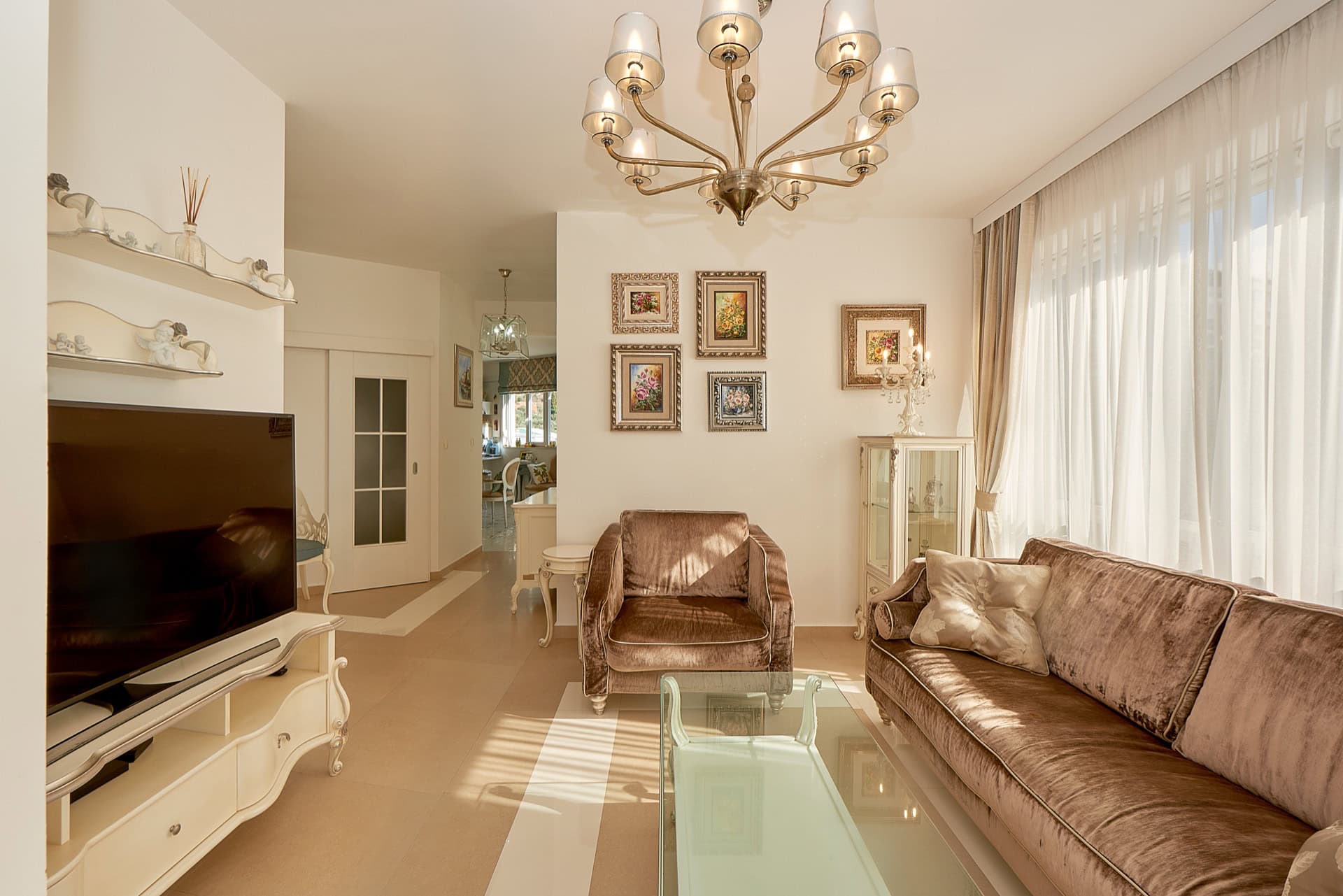 Geräumiges Wohnzimmer mit Samtsofa, Sessel, Fernseher und Kronleuchter im Penthouse, Bečići, Montenegro