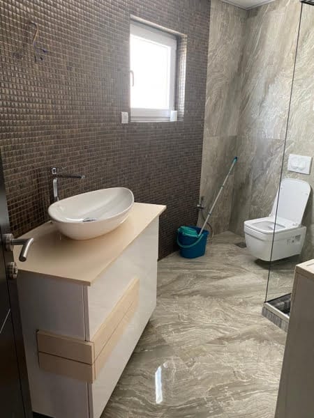 Modern bathroom in a house, Shushan, Montenegro: mosaic finish, vessel sink, and wall-mounted toilet.