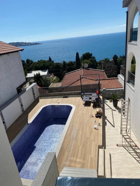 View of the pool and sea from the terrace of a house in Šušanj, Montenegro: modern finishes, lounge area, and panoramic sea view.
