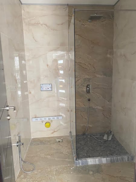 Modern bathroom with a shower cabin and light marble finishes in a house, Shushan, Montenegro.