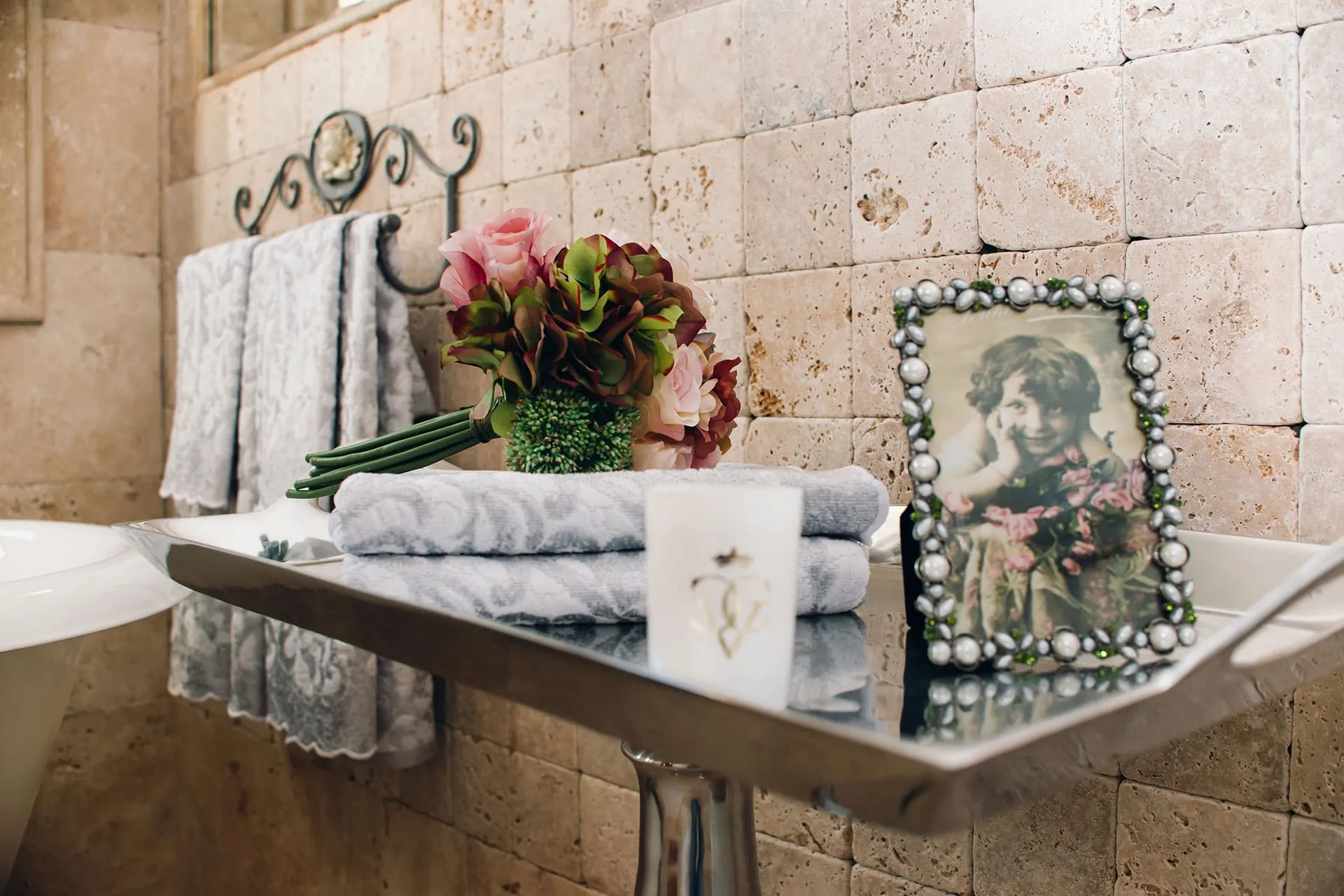 Bathroom in a villa in Reževići, Montenegro: natural stone finishes, decor, towels, and a stylish interior.