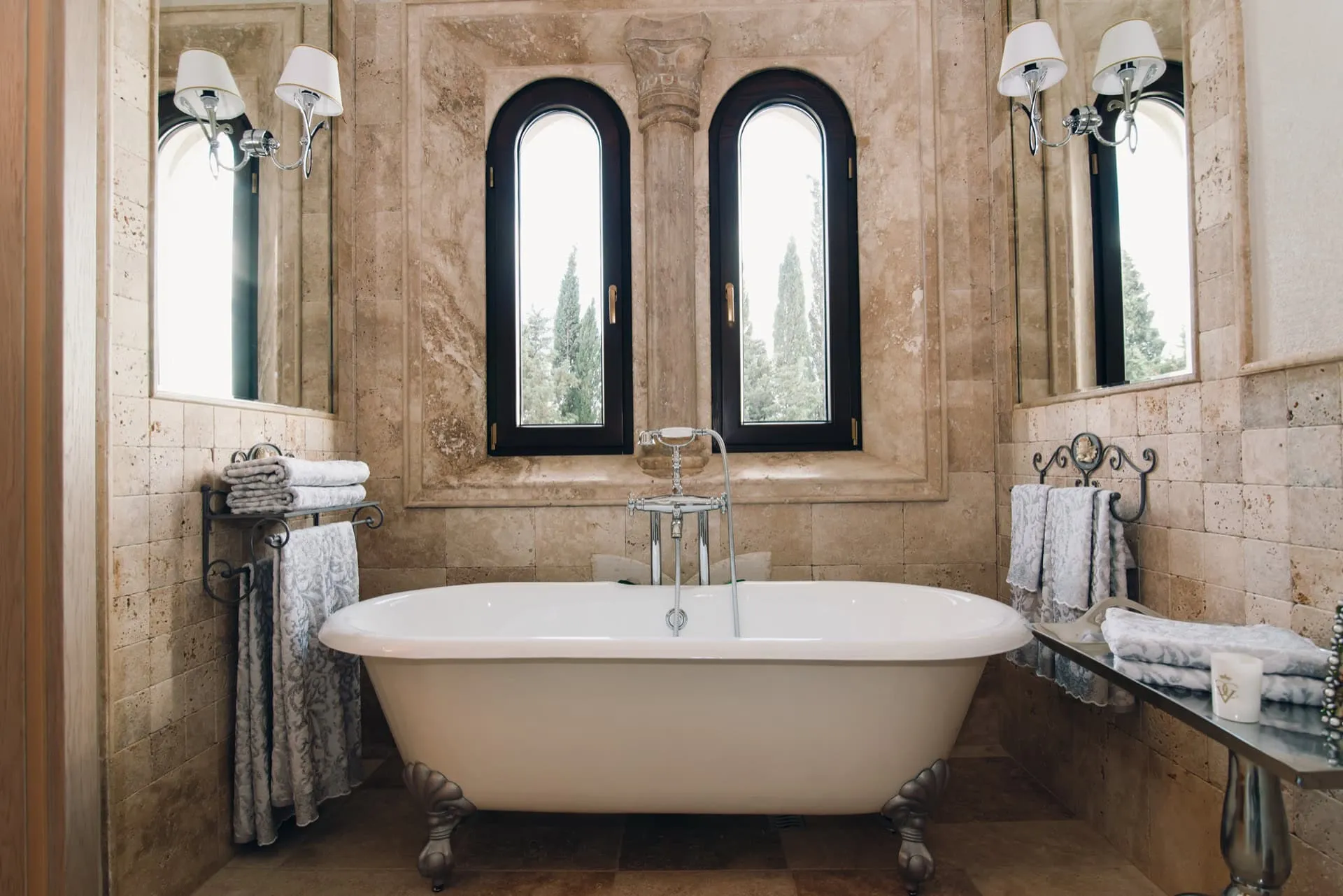 Luxurious bathroom with a freestanding bathtub and travertine finishes in a villa in Reževići, Montenegro.