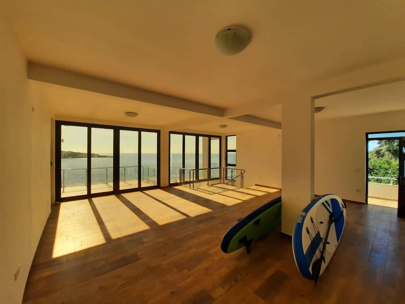 Salon spacieux avec baies vitrées et vue sur la mer dans une villa à Dobra Voda, Monténégro.