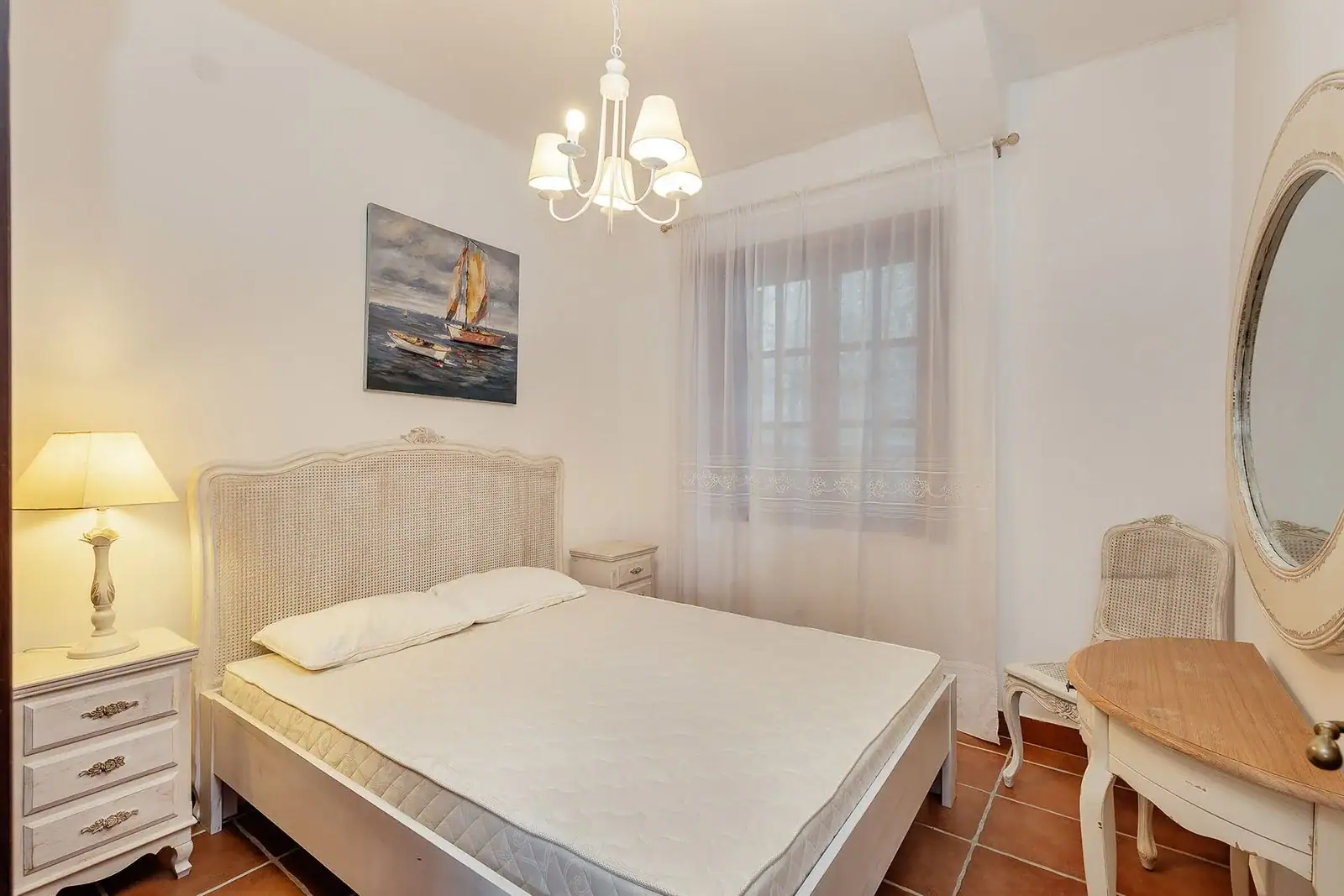 Bright classic-style bedroom with a double bed and vintage furniture in an apartment, Kostanica, Montenegro.