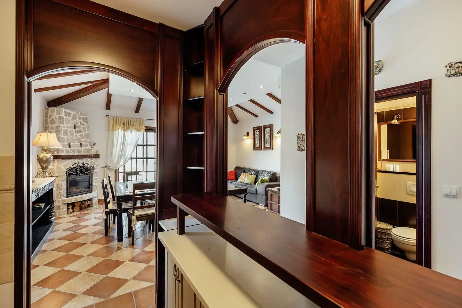 Living room interior with a fireplace and wooden arches in an apartment in Kostanica, Montenegro.