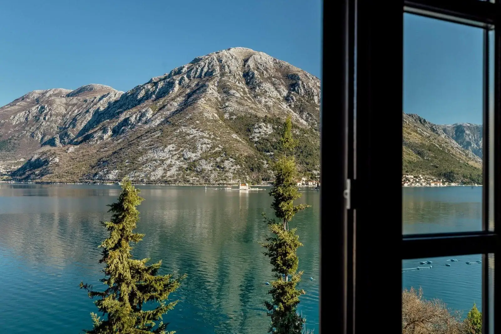 Panoramic view from the bedroom window of Kotor Bay and the mountains in Kostanjica, Montenegro, overlooking the island of Our Lady of the Rocks.