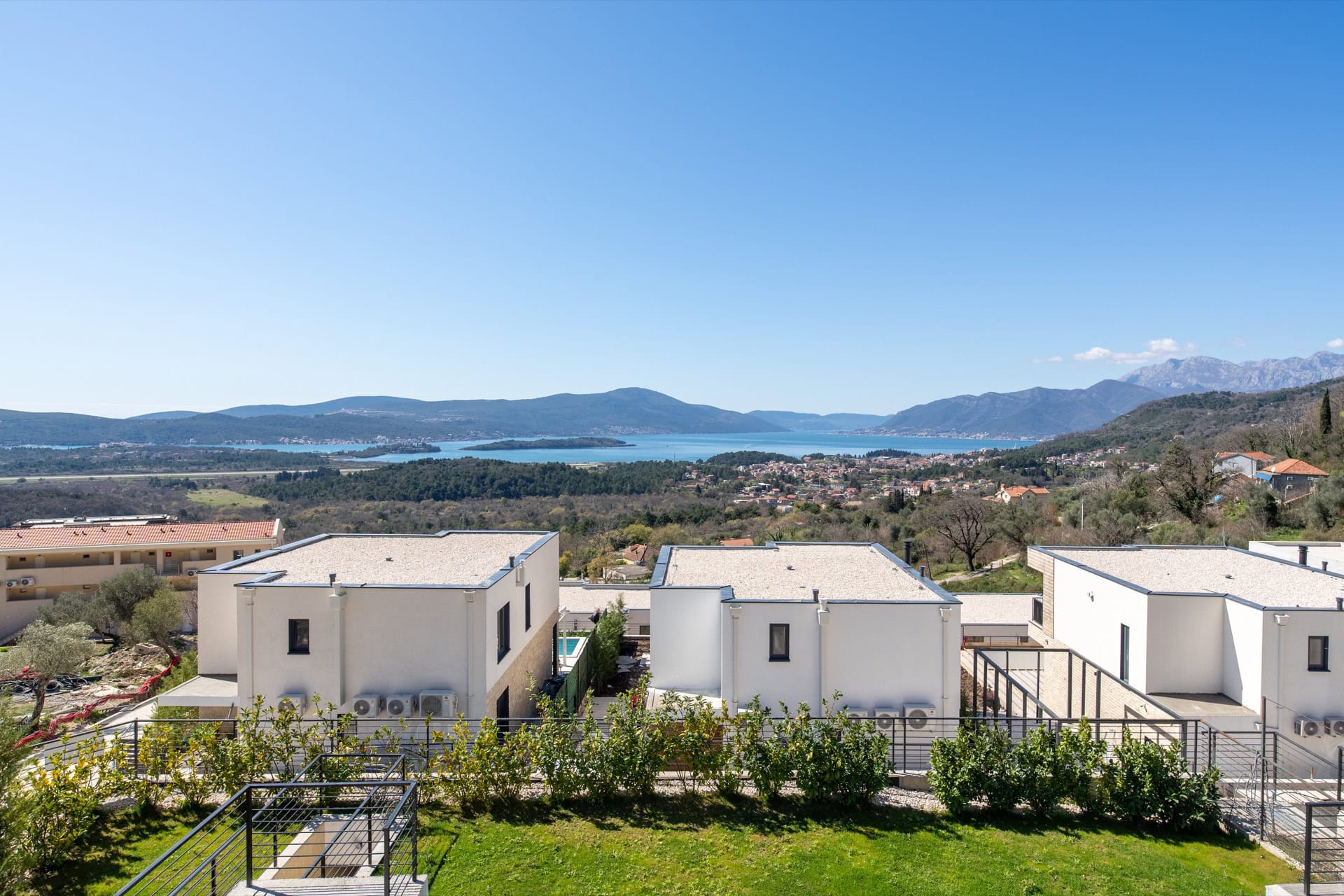 Panoramic view of Tivat Bay and modern villas in the village of Kavac, Montenegro. Sunny day, mountain landscape.