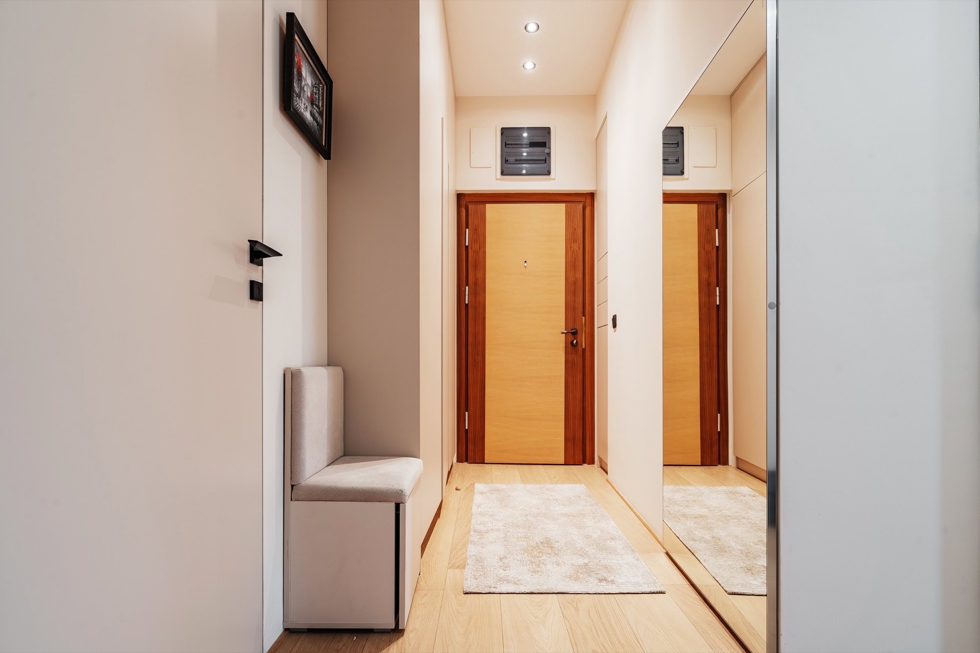 Moderne Diele mit Spiegelschrank und heller Ausstattung in einer Wohnung in Bečići, Montenegro.