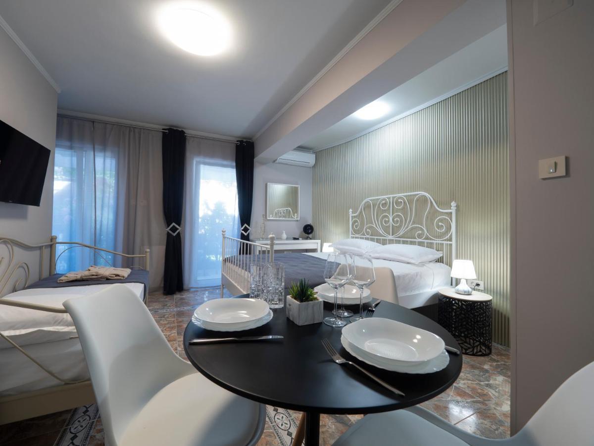 Cozy bedroom in a hotel in Pržno, Montenegro: double bed, dining table, modern finishes, and access to the balcony.