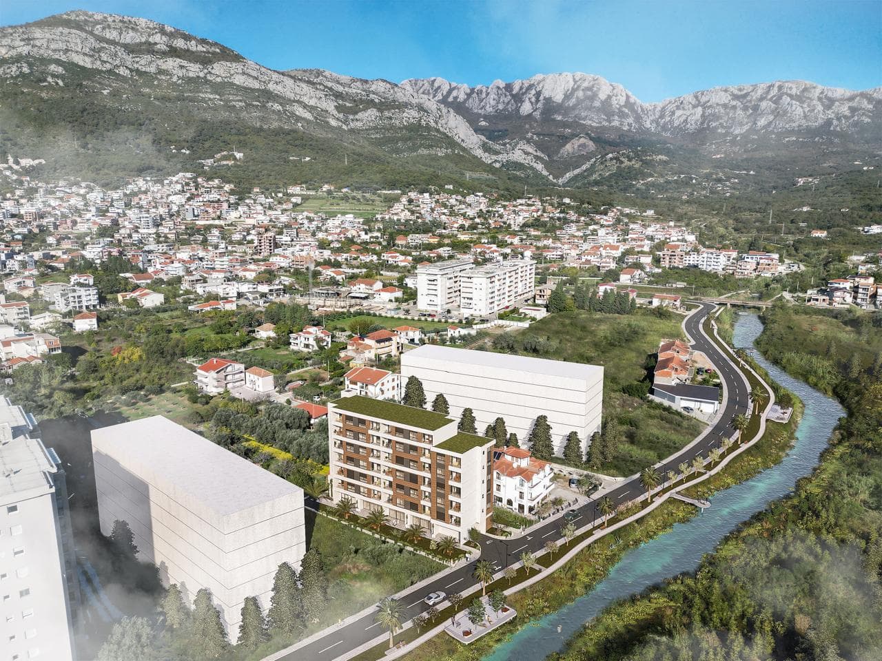 Aerial view of a new residential complex in Bar, Montenegro, near a river and mountain scenery.