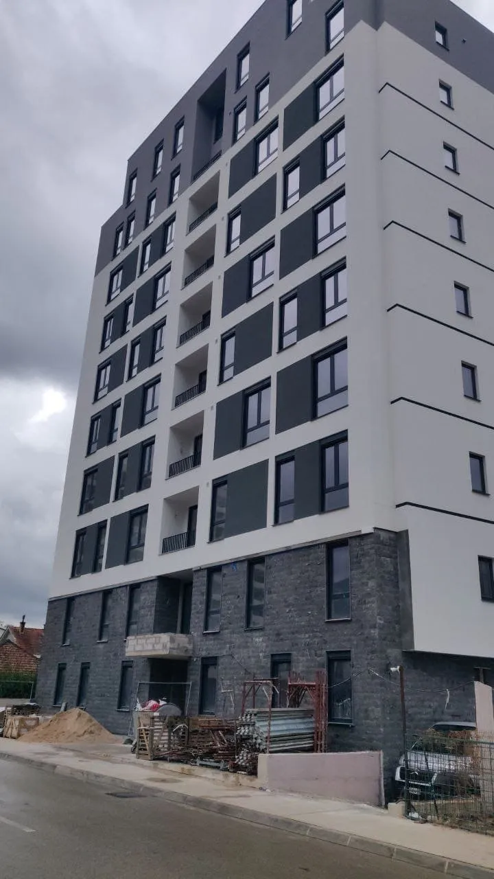 Multistory residential building of modern architecture with gray and white facade.