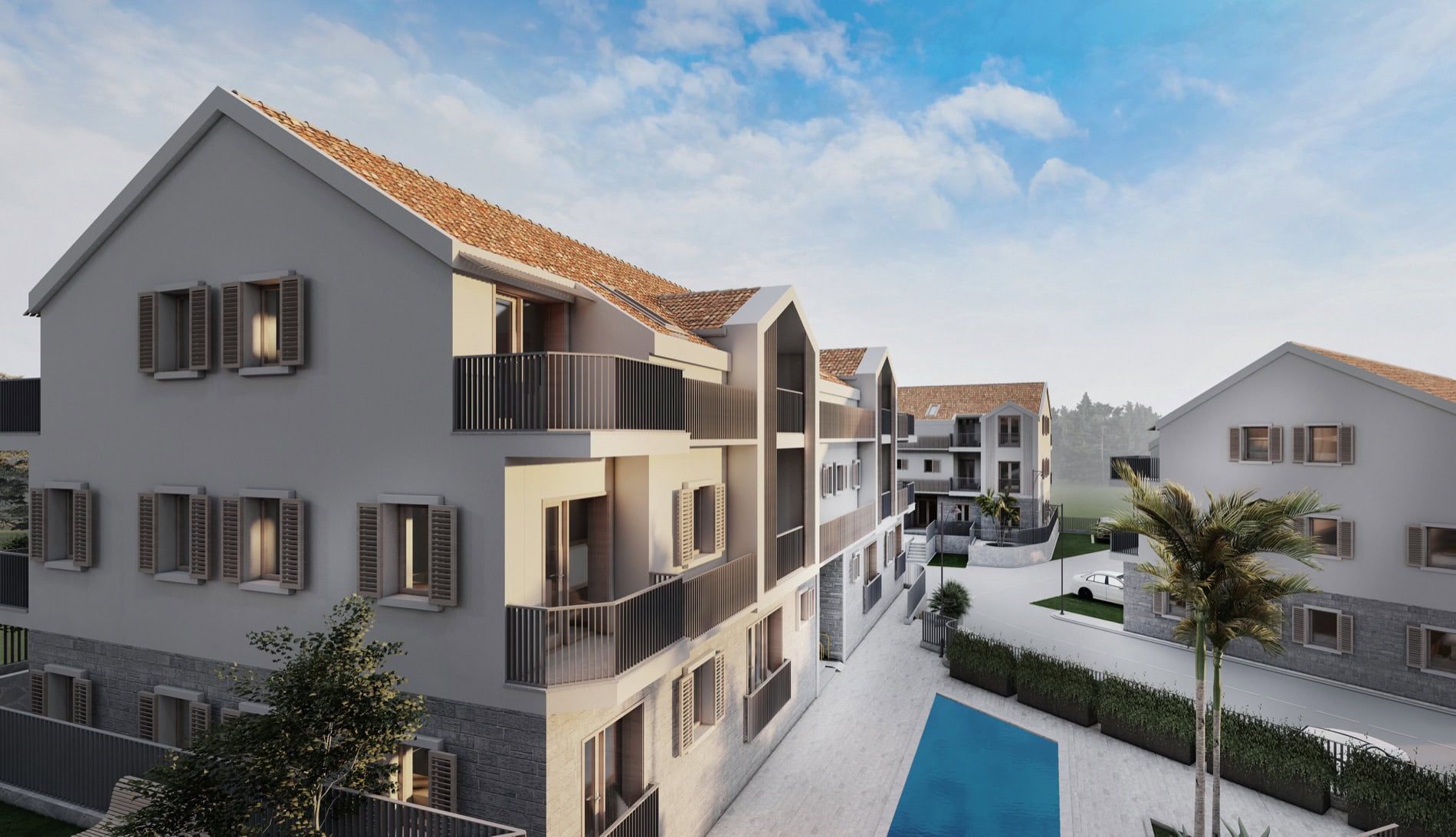 Complexe résidentiel moderne à Risan, Monténégro : immeubles de faible hauteur avec toits en tuiles, balcons et piscine.