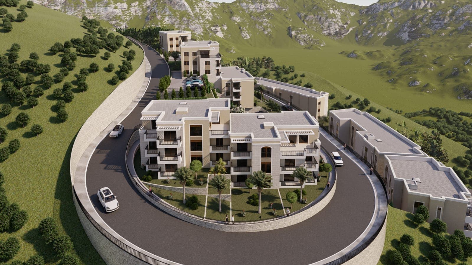 Blick von oben auf eine Wohnanlage in den Bergen von Budva, Montenegro: moderne Häuser, gepflegte Außenanlagen und Parkplätze.