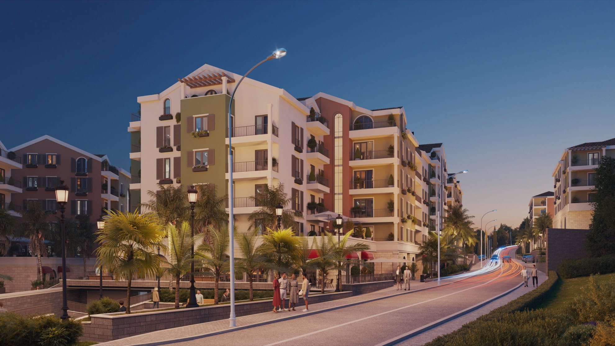 Tivat, Karadağ'da modern konut kompleksi: balkonlu binaların cephesi, palmiye ağaçları ve akşam sokak aydınlatması.