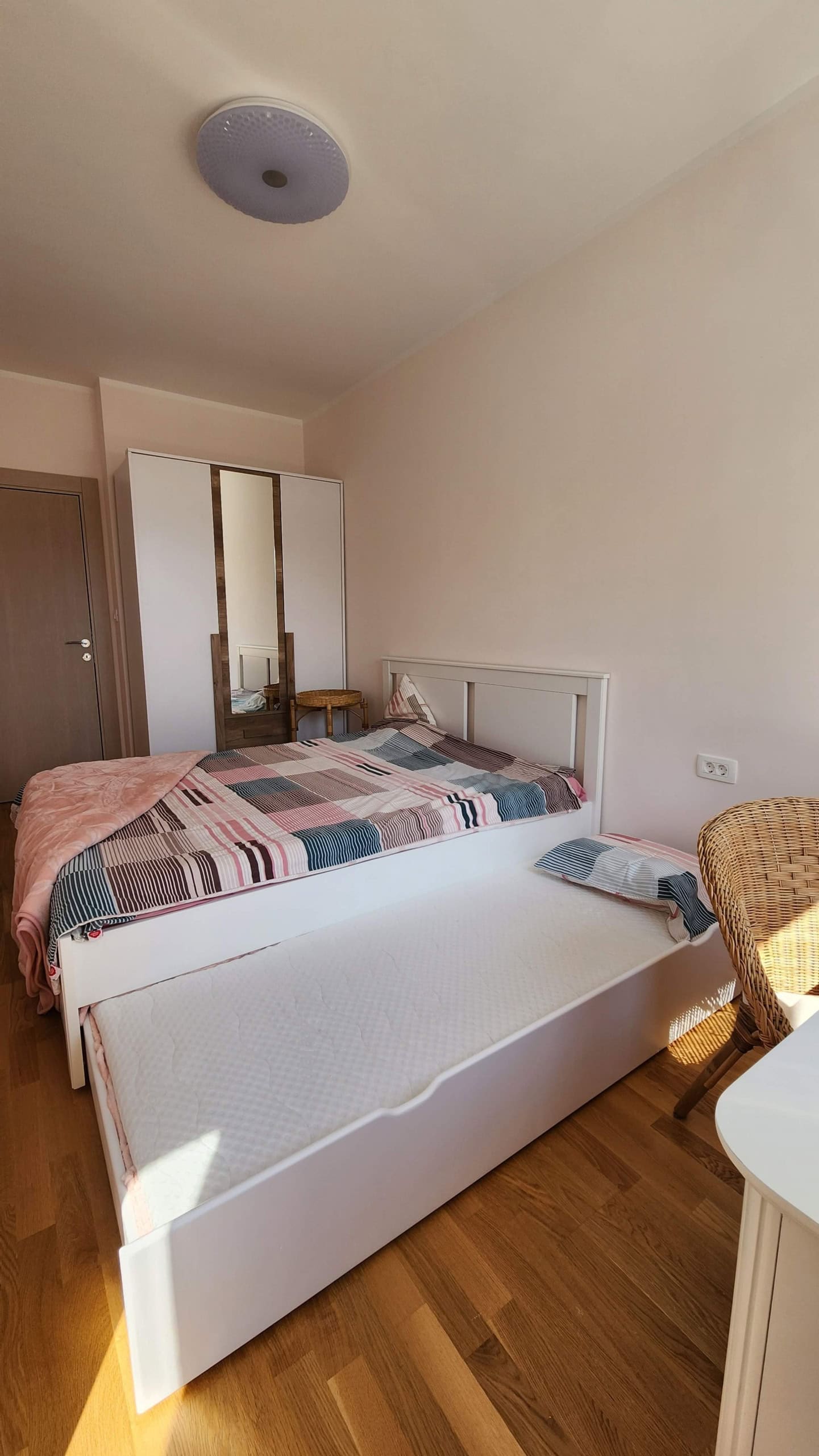 Bright bedroom with a double bed and an extra sleeping space in an apartment, Budva, Montenegro.