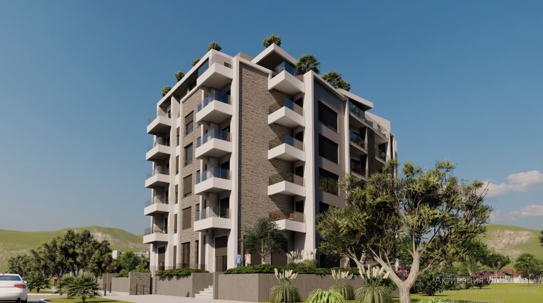 Complexe résidentiel moderne à Šušanj, Monténégro : façade avec parement en pierre, balcons et terrasses sur le toit.