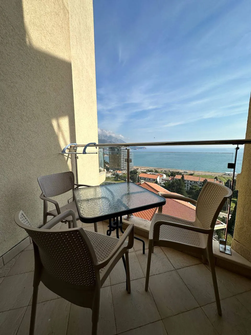 Balcony with furniture and panoramic sea view in an apartment in Bečići, Montenegro.
