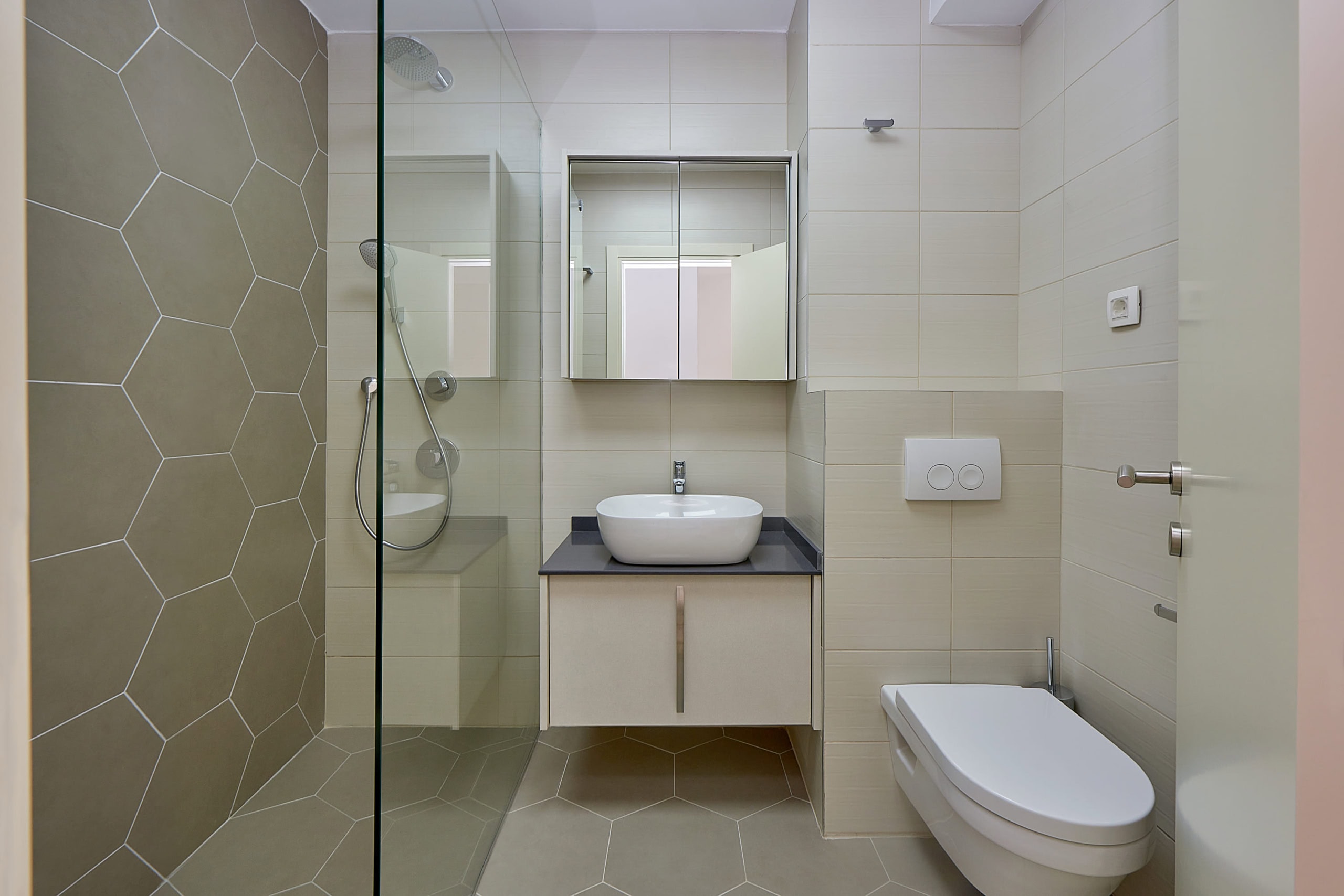 Modern bathroom in an apartment in Dobrota, Montenegro: shower cabin, wall-mounted fixtures, and stylish tile.