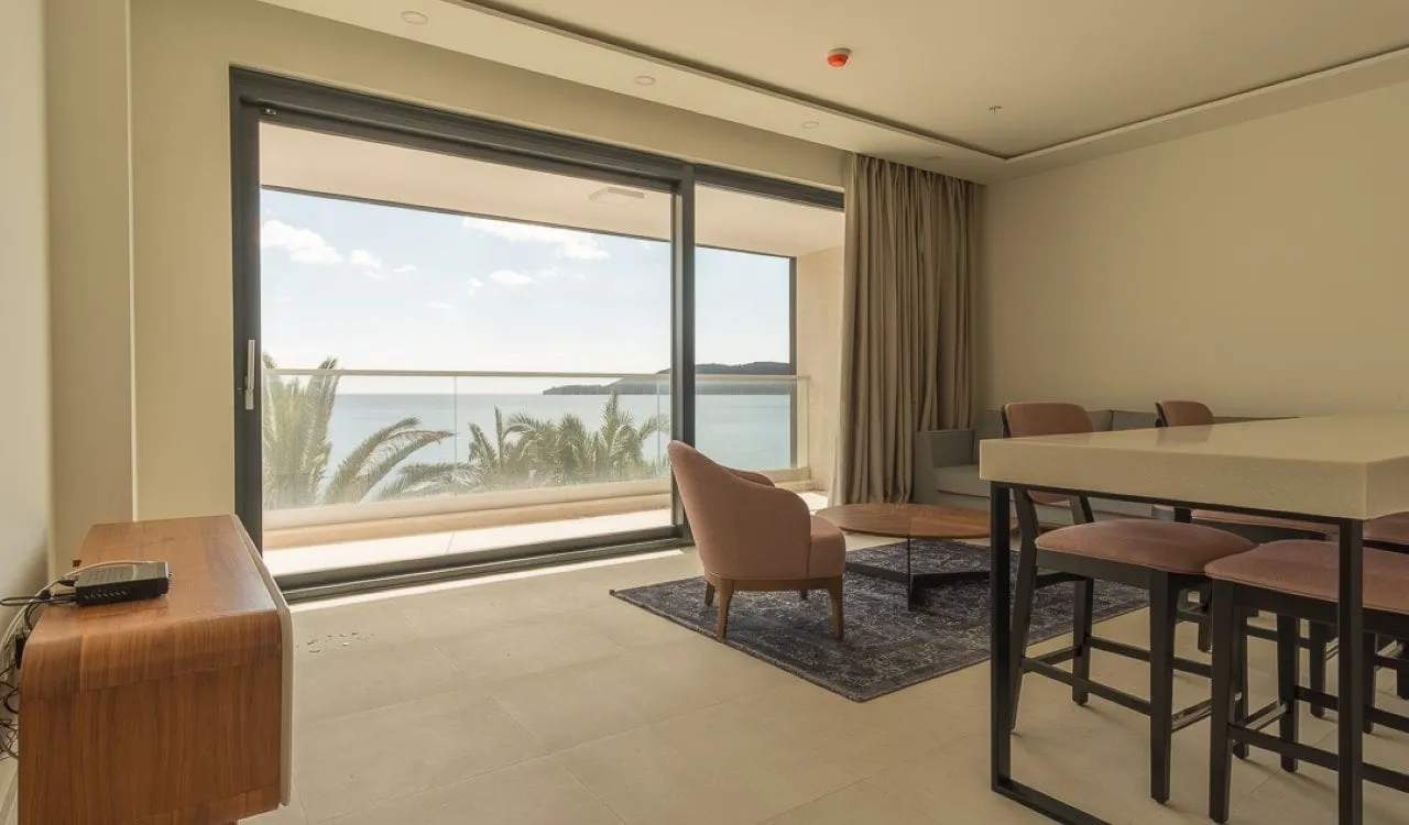 Modern living room with panoramic windows and sea view in an apartment in Bečići, Montenegro