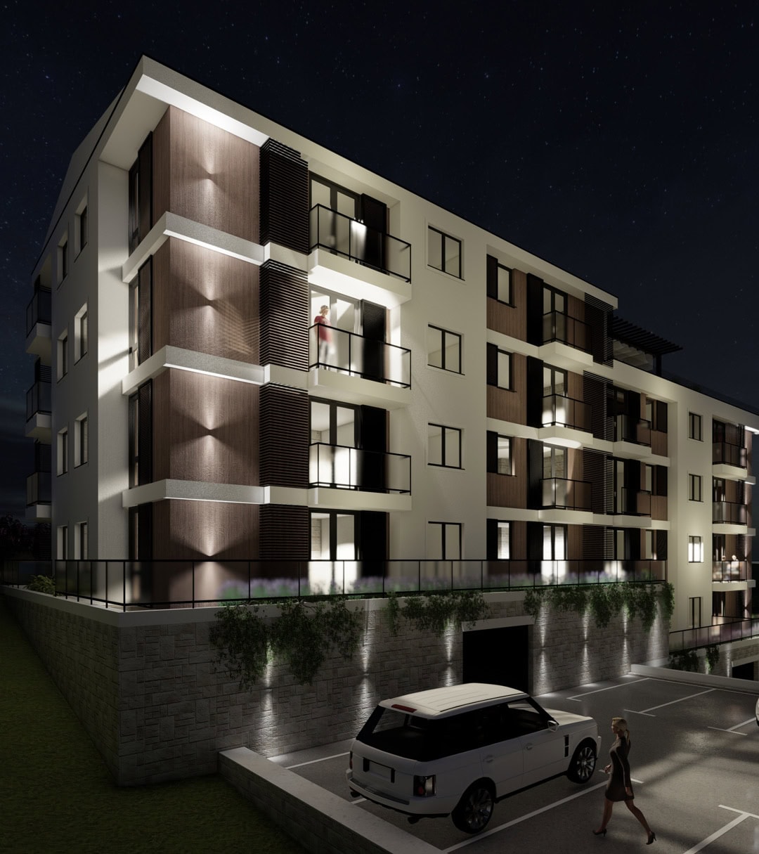 Moderner Wohnkomplex in Tivat, Montenegro: nächtliche Fassade mit Beleuchtung, Balkonen und Parkplatz am Gebäude.