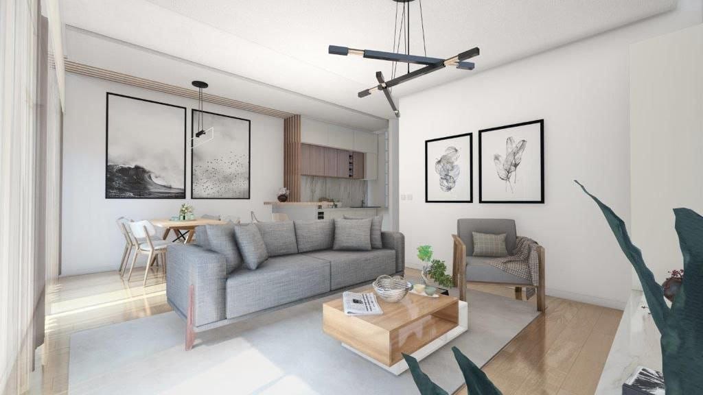 Nowoczesny salon z kuchnią w ЖК Dobrота, Czarnogóra: szara sofa, drewniany stolik i stylowe wnętrze.