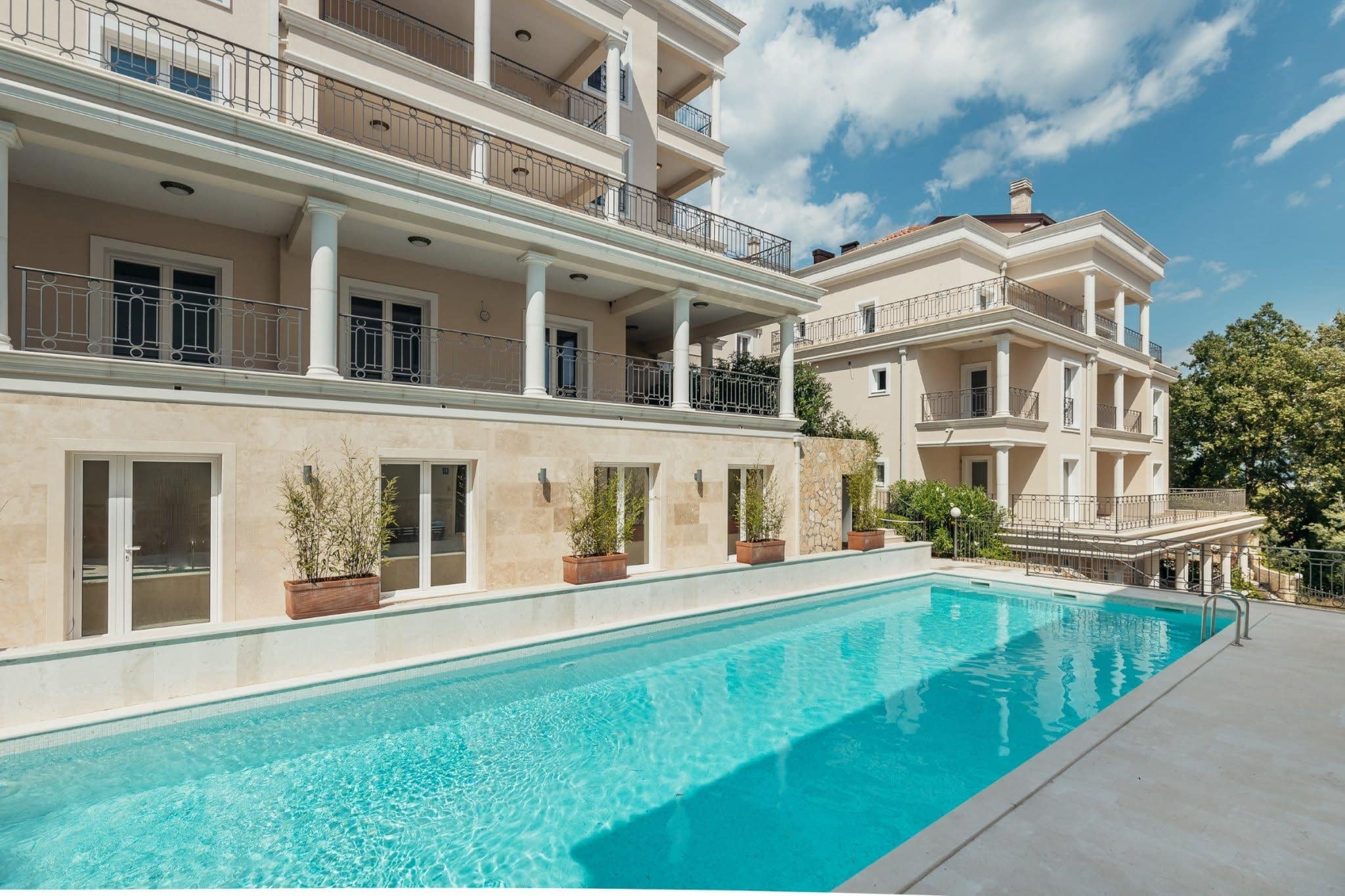 Pool an einem exklusiven Wohnkomplex in Kumbor, Montenegro: moderne Villa mit Terrassen und Steinverkleidung der Fassade.