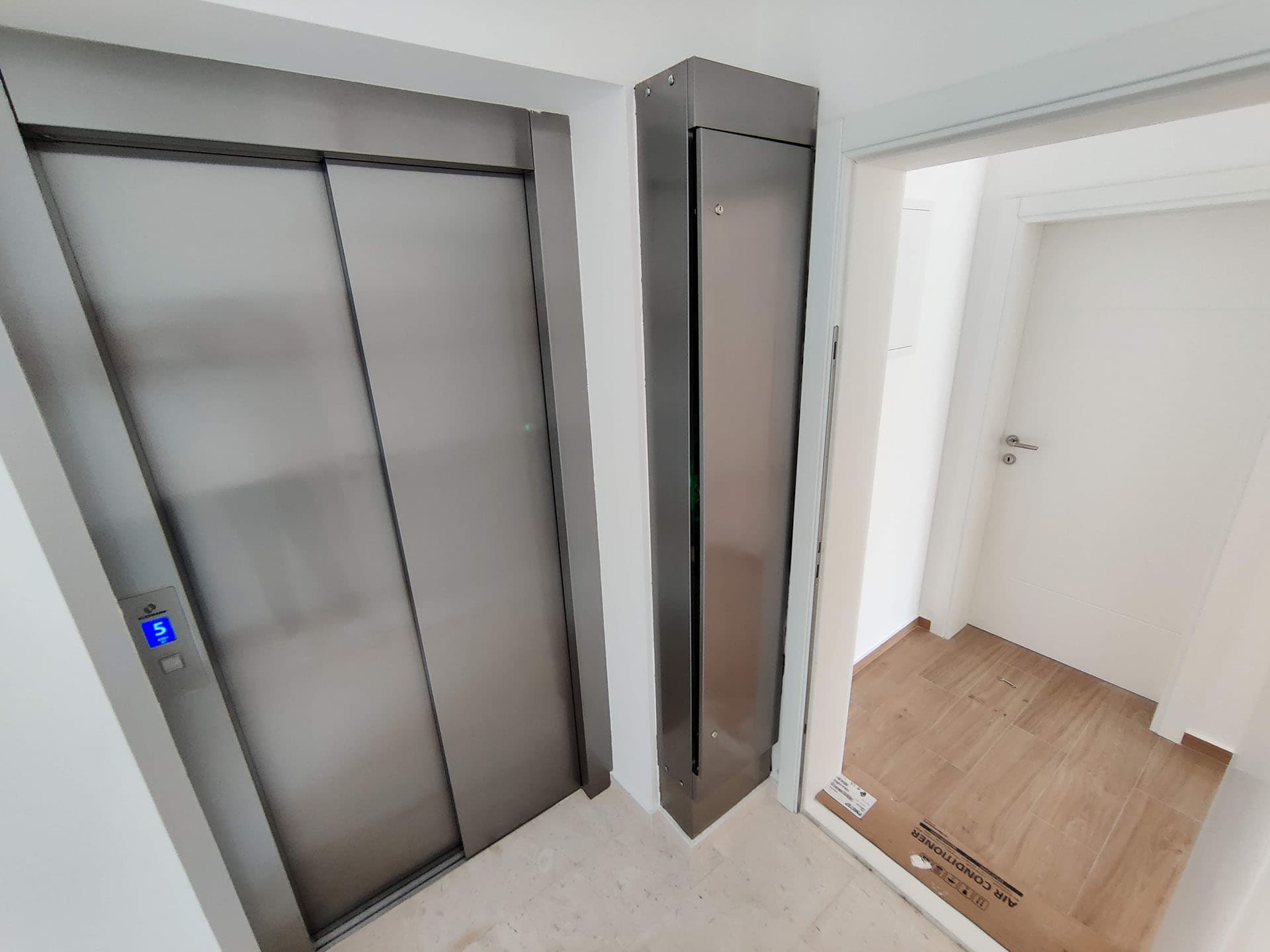 Modern elevator and apartment entrance with finishing in a residential complex in Becici, Montenegro.