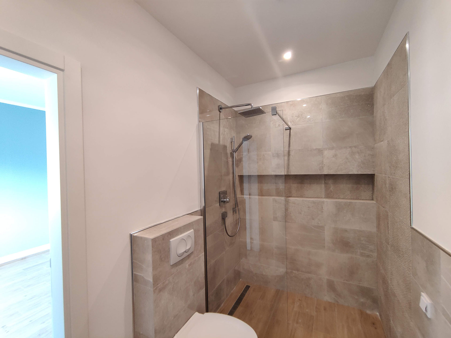 Modern bathroom with a shower cabin and beige tiles in an apartment, Bečići, Montenegro