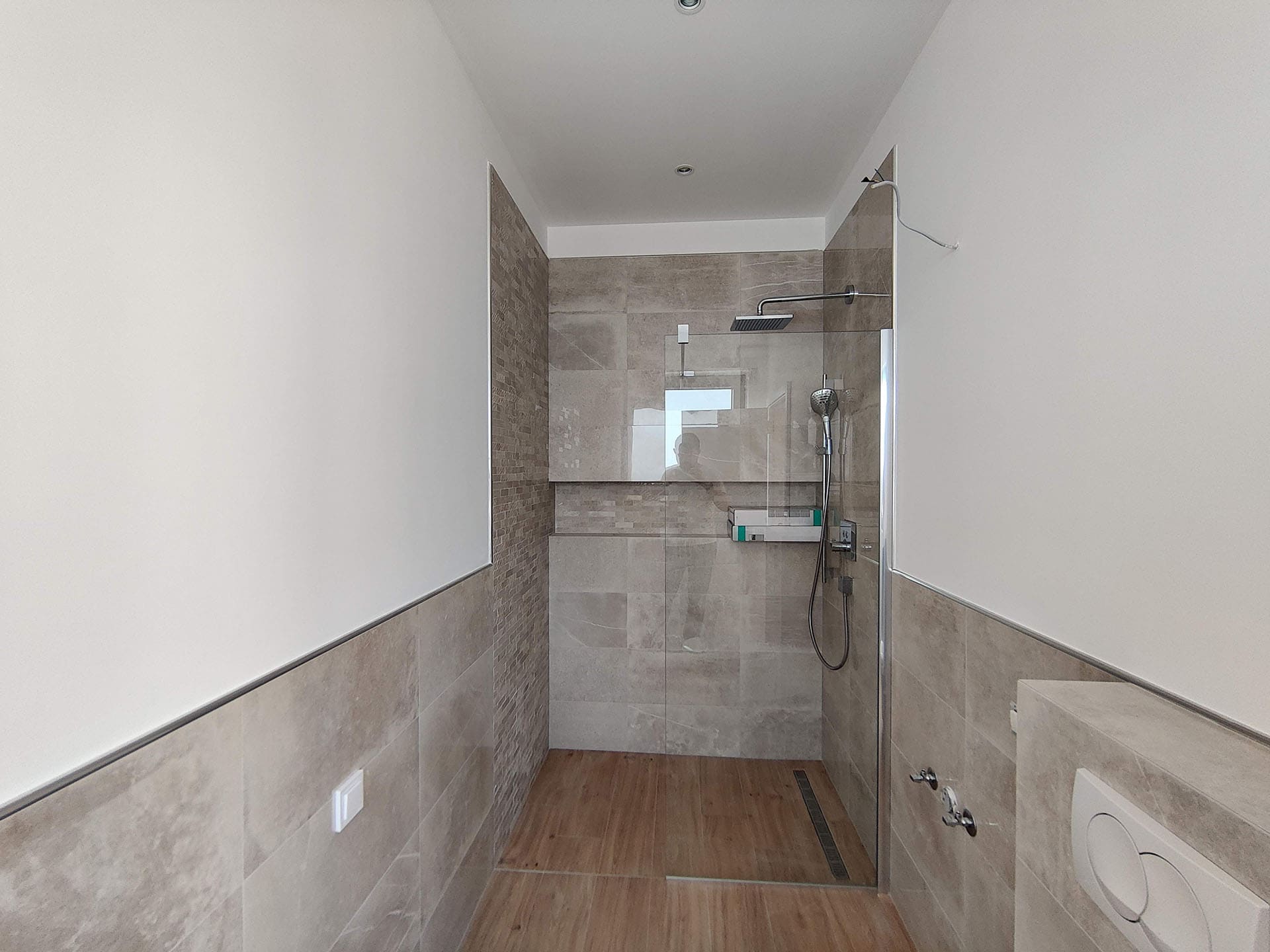 Modern bathroom with a shower cabin and tiled finishes in an apartment in Bečići, Montenegro.