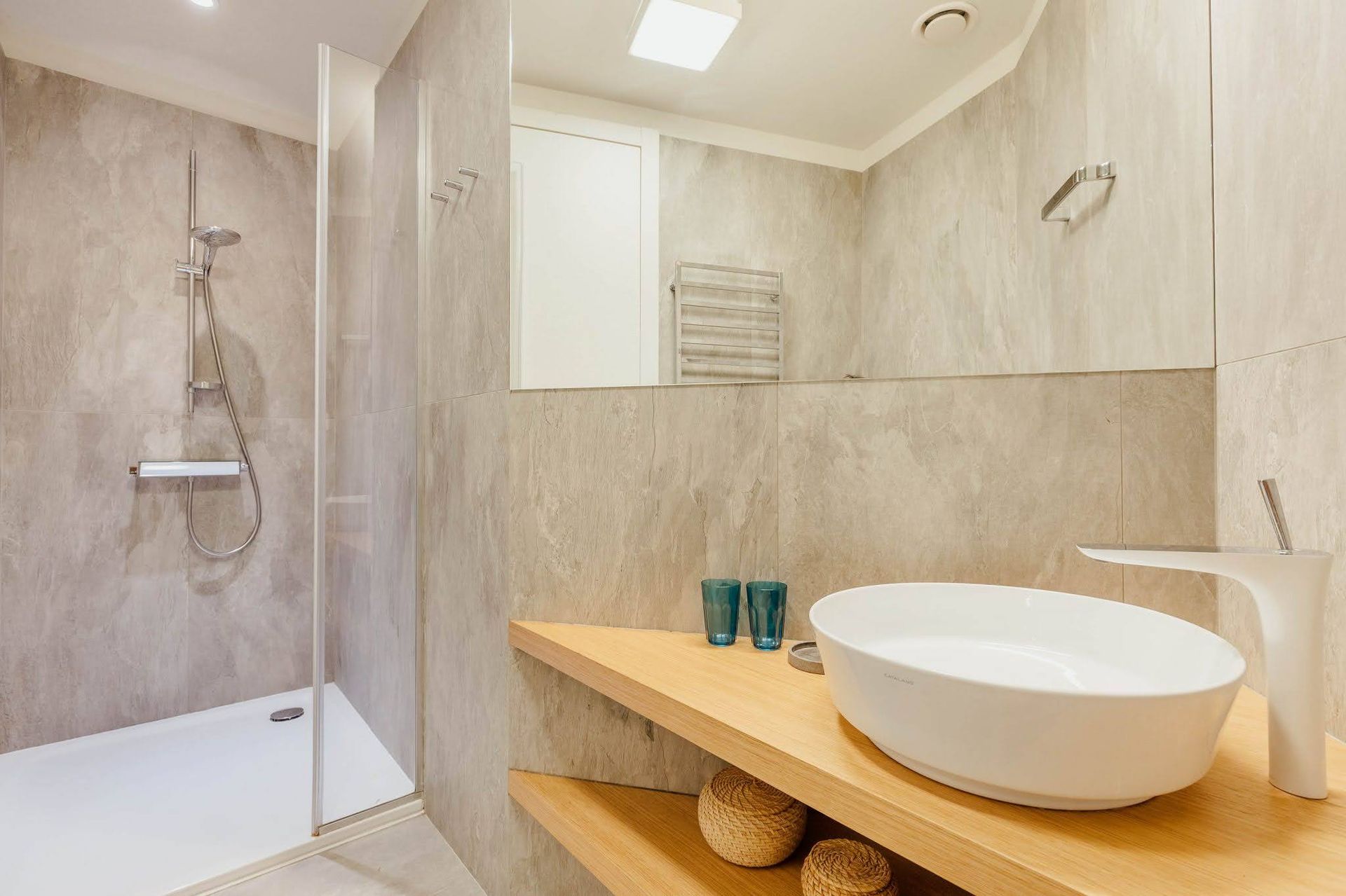 Modern bathroom with a shower cabin and wooden countertop in a villa in Pržno, Montenegro
