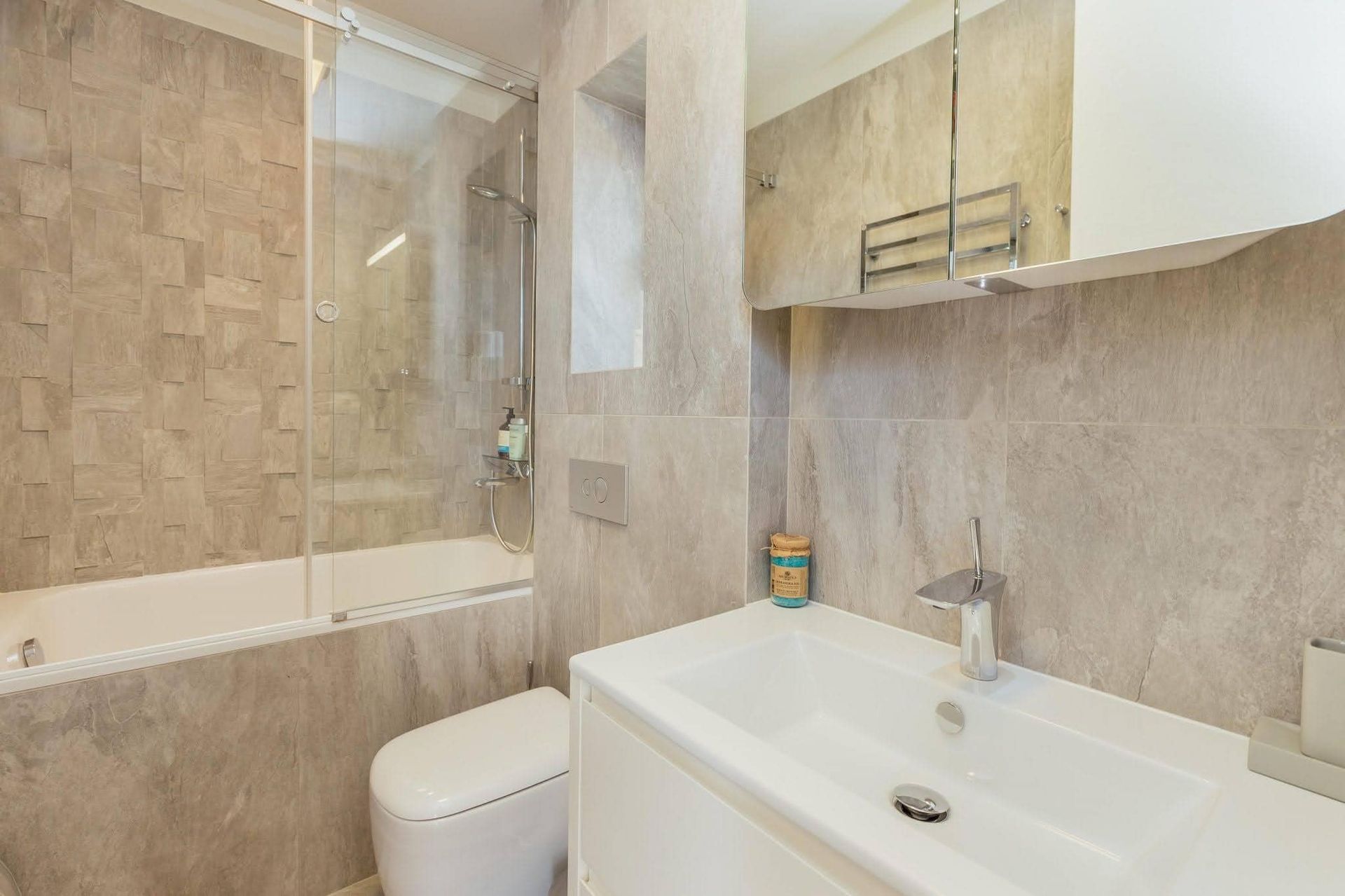 Modern bathroom with a shower cabin and light-colored tiles in a villa in Pržno, Montenegro.