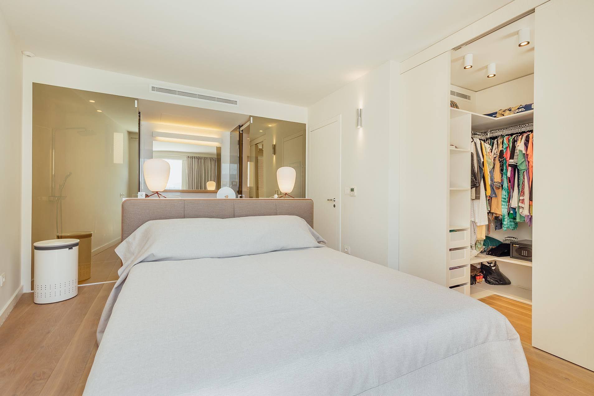 Modern bedroom with a double bed and built-in wardrobe in a villa in Pržno, Montenegro.