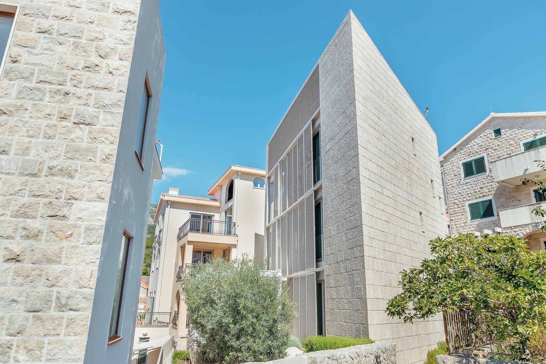 Modern villa with a stone facade and panoramic windows in Pržno, Montenegro: exterior view of the building.
