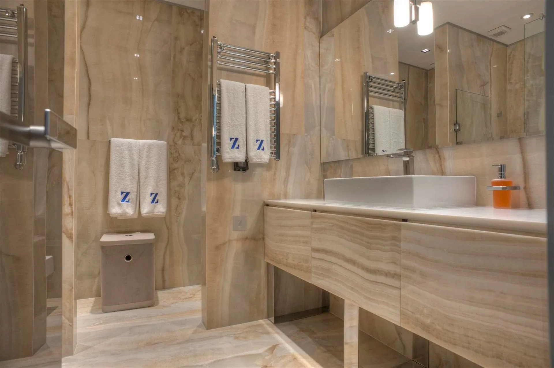 Karadağ, Krašići’deki villada bej mermer kaplamalı modern banyo: lavabo ve şık dekor.
