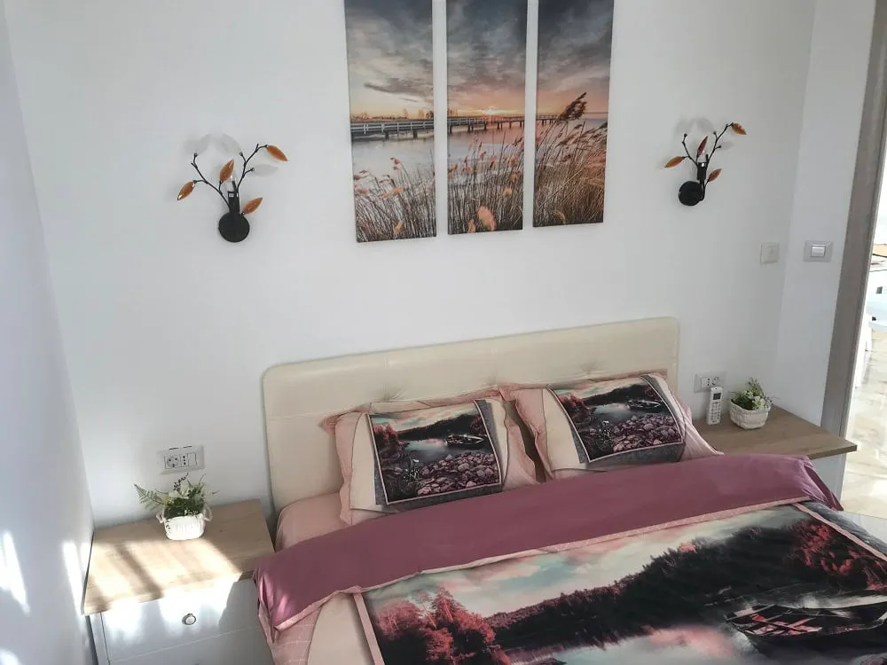 Cozy bedroom with a double bed in an apartment, Dobrye Vody, Montenegro: modern interior and decor.