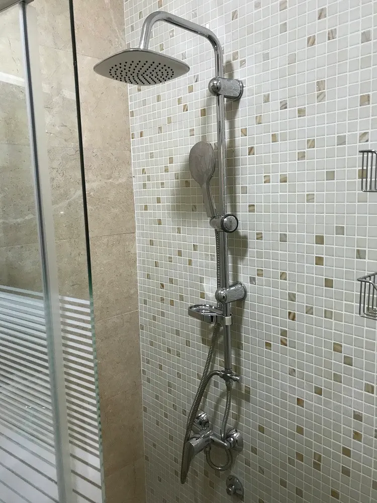 Modern shower cabin with a rain shower in the bathroom of an apartment in Dobri Vody, Montenegro.