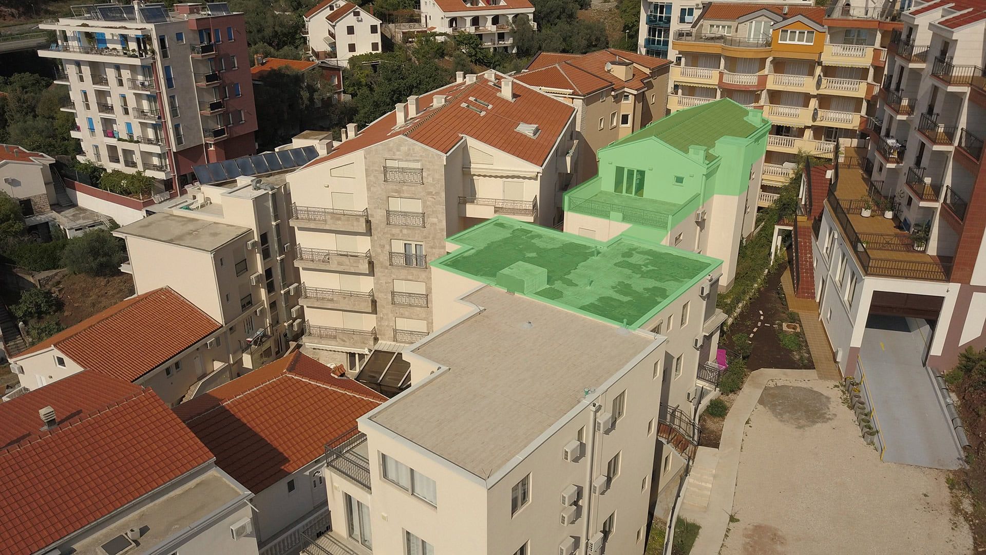 Aerial view of a residential complex in Pržno, Montenegro, with penthouses and terraces highlighted in green.